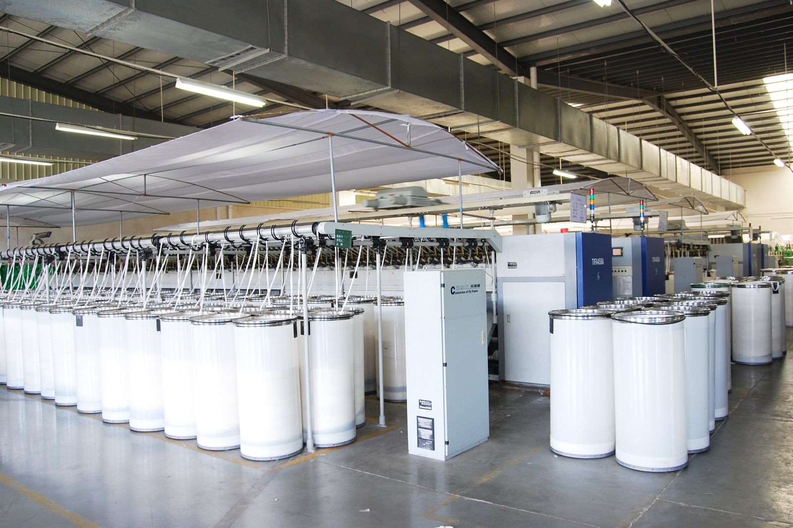 Drawing line and sliver cans on the factory floor