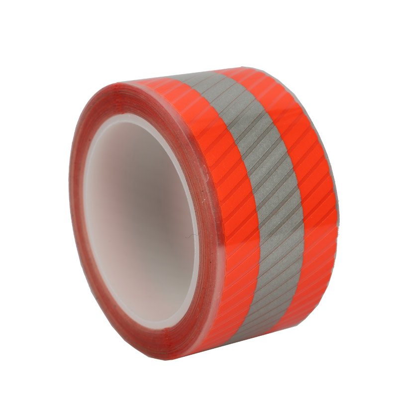 Retroreflective safety tape with a red fluorescent face and a silver reflective stripe